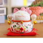 Figura de cerámica de un gato de la suerte japonés